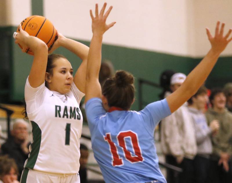 Grayslake Central's Addi Thomas passes the ball as she is guarded by Marian Central's Adriana Wrzos  during a nonconference girls basketball on Monday, Jan. 13, 2025, at Grayslake Central High School.