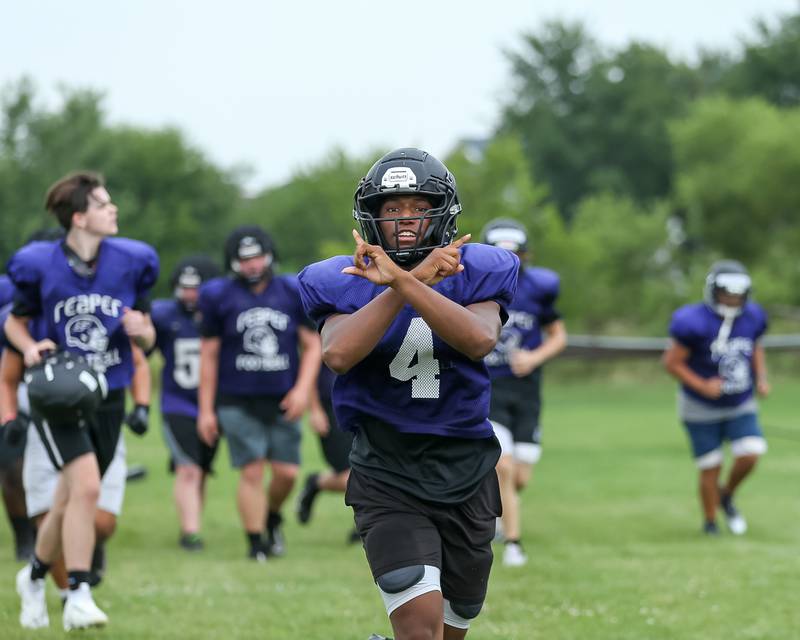 Andrew Cox runs off the field with the rest of the line for a water break at Plano High School football practice.  August 9, 2023.