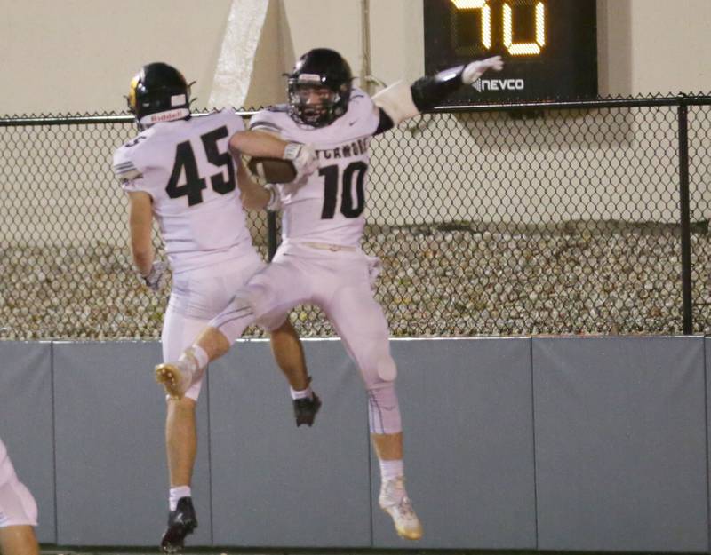 Sycamore's Zach Crawford (10) celebrates with teammate Kaden Ladas (45) after scoring a touchdown against L-P  on Friday, Oct. 14, 2022 at Howard Fellows Stadium in Peru.