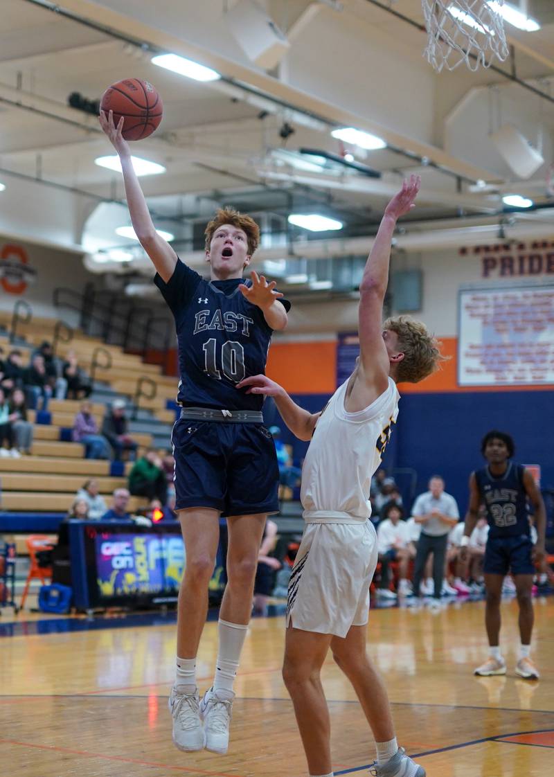 Oswego East's Noah Mason (10) shoots the ball in the post against Neuqua Valley during a hoops for healing basketball tournament game at Oswego High School on Friday, Nov 24, 2023.