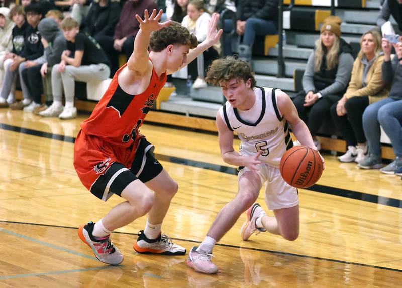 Sycamore's Preston Picolotti tries to get by Sandwich's Griffin Somlock during their game Friday, Nov. 24, 2023, in the Leland G. Strombom Holiday Tournament at Sycamore High School.