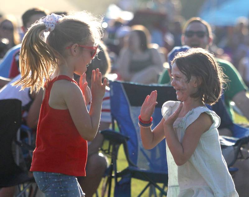 Children dance to the sounds of the Modern Day Romeos during the Stars N’ Stripes Fest at Cary-Grove Park in Cary on Saturday, June 28, 2025.