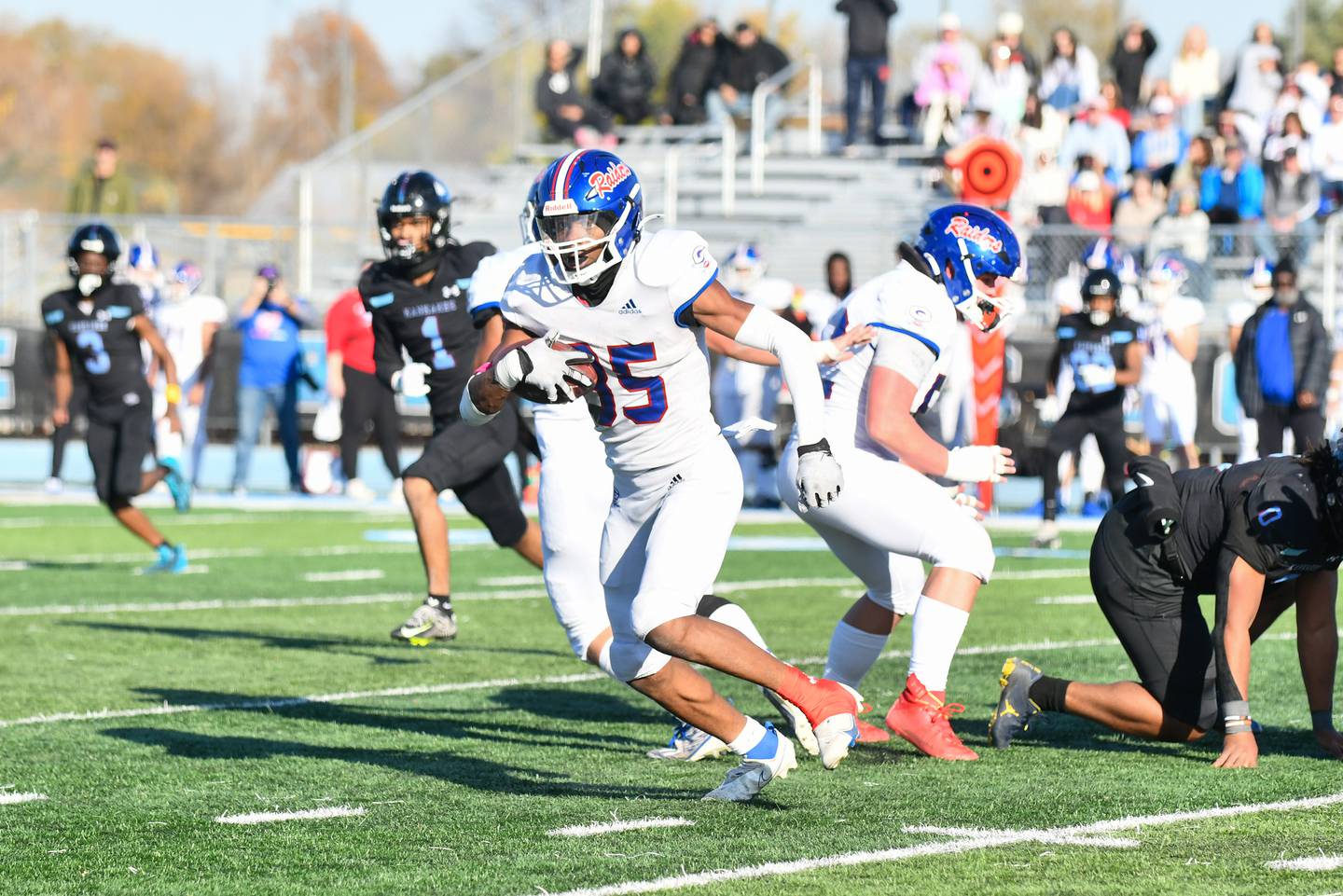 Glenbard South's Devontae Clark runs the ball Saturday during the Raiders' 42-0 loss to Kankakee in the first round of the IHSA Class 6A playoffs.