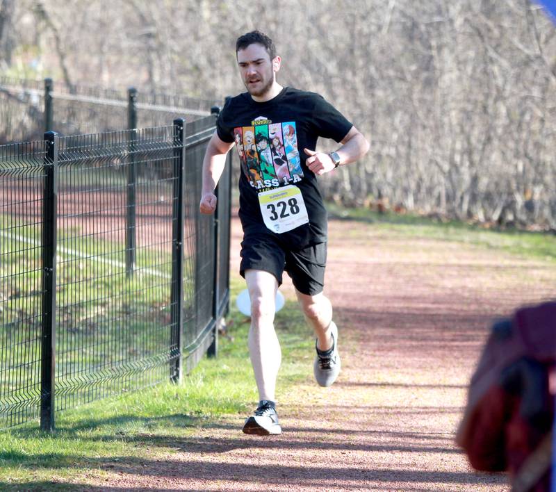 Jade Sherwin of Carol Stream was the first runner to finish the Wheaton Park District’s Superhero 3K Fun Run at the Sensory Garden Playground in Lisle on Saturday, April 6, 2024.