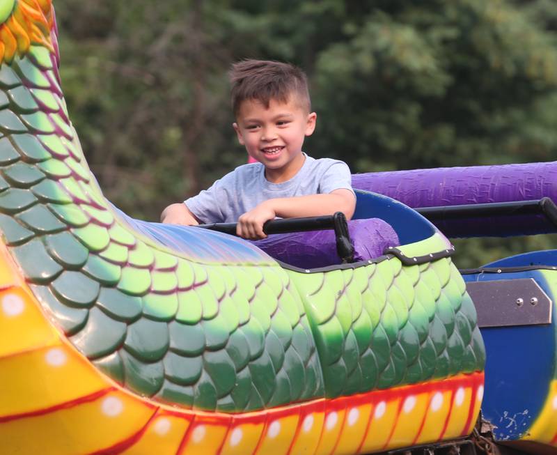 Aiden Hanley 6, of Ottawa rides the dragon carnival ride at the Lions Club Carnival on Thursday, June 15, 2023 in Ottawa.