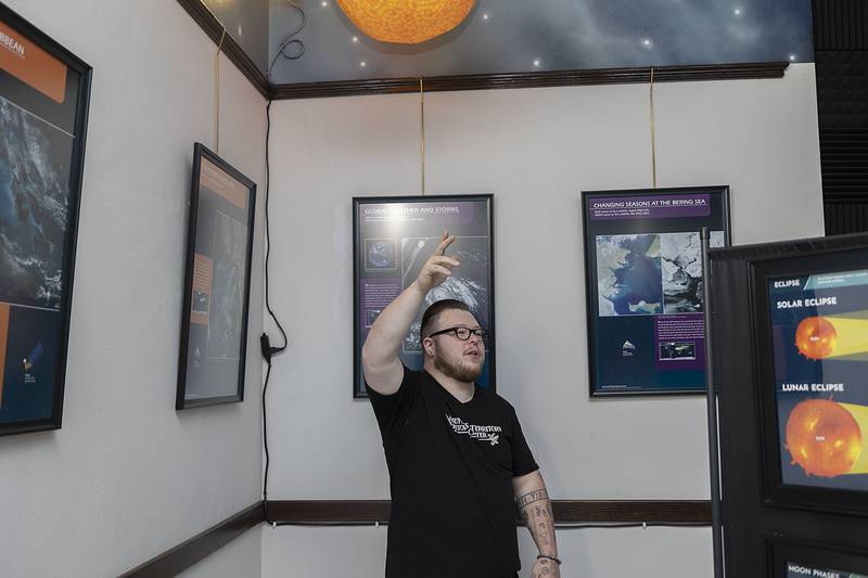 Northwest Territory Historic Center director Jake Wallin gestures while speaking about the new center’s “Earth from Space” exhibit on Tuesday, May 2, 2023. The exhibit takes the viewer through informational posters, models and interactive screens about space and space travel.