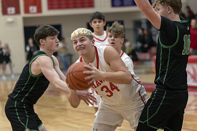 Oregon’s Kade Girton works in the lane against Rock Falls defenders Tuesday, Dec. 12, 2023 in Oregon.