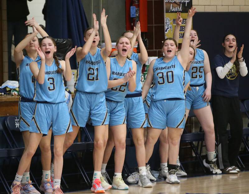 Members of the Marquette girls basketball team react after pulling ahead of St. Bede in the first quarter during the Class 1A Regional semifinal game on Monday, Feb,. 12, 2024 in Bader Gym.