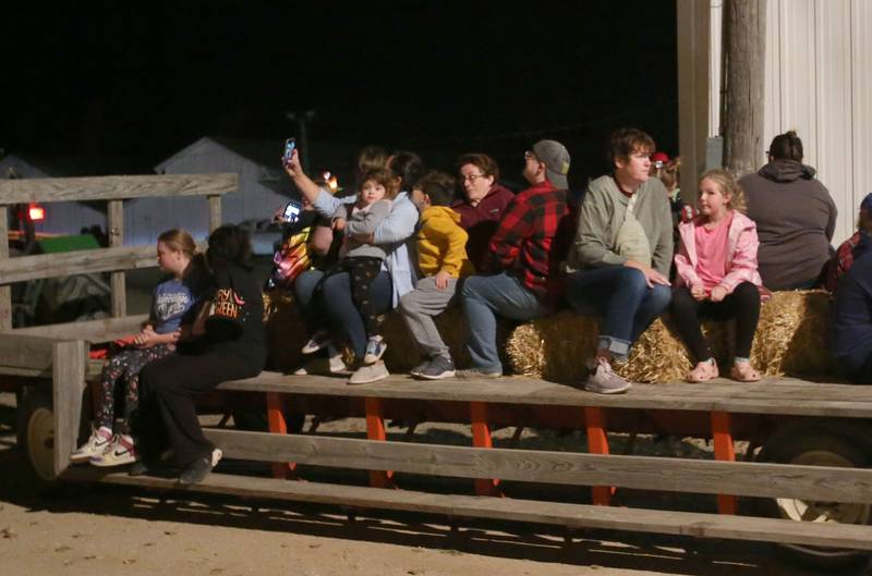 Visitors ride a hayrack during the Monster Mash Balloon Bash on Saturday, Oct. 12, 2024 at the Bureau County Fairgrounds in Princeton.