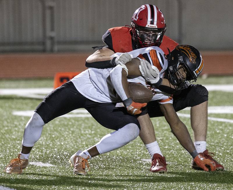 Milledgeville’s Micah Toms-Smith is tackled in the backfield by Amboy’s Evan Flanagan Friday, Nov. 22, 2024, during the 8-man football championship in Monmouth.