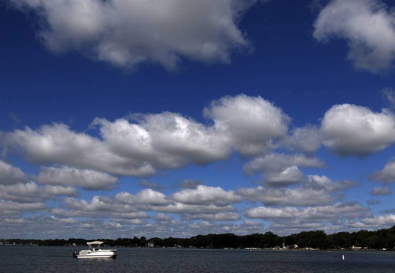 A pontoon boat travels around Crystal Lake near Main Beach on  Wednesday, Aug. 30, 2023.