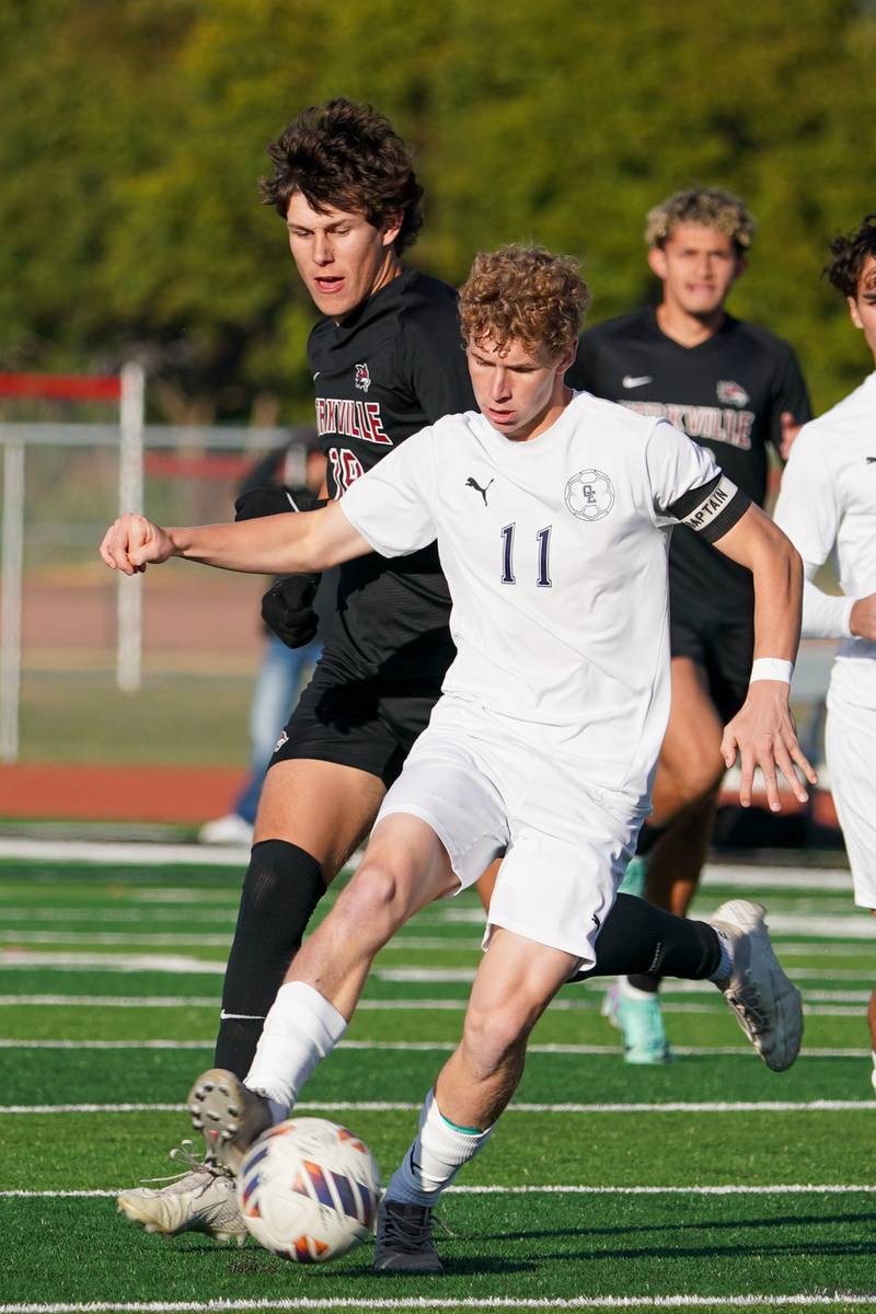 Oswego East's Caleb Pankiewicz (11) plays the ball against Yorkville's Kyle Nadler (19) during a soccer match at Yorkville High School on Tuesday, Oct. 15, 2024.