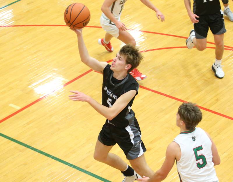 Kaneland's Brad Franck runs in the lane and drives to the hoop past L-P's Seth Adams on Tuesday, Dec. 12, 2023 in Sellett Gymnasium.