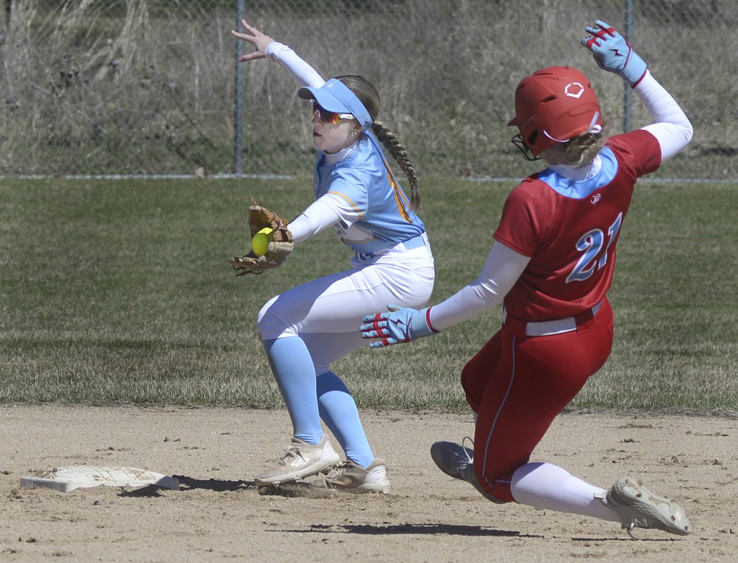 Joliet Catholic’s Stella Jasper reaches for the bag to force out  Ottawa’s Piper Lewis  at 2nd base in the 3rd inning Saturday at Ottawa.