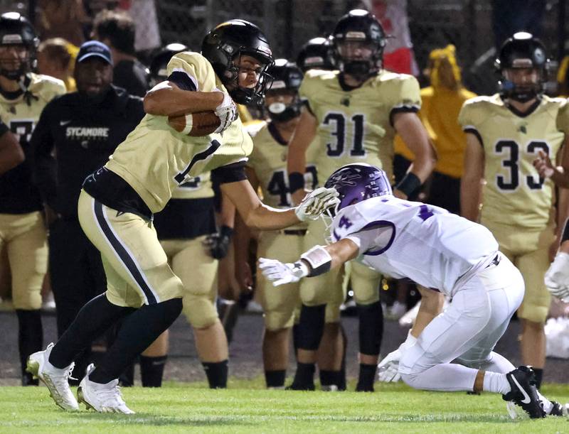 Sycamore's Josiah Mitchell tries to get by Rochelle's Keagan Albers after making a catch during their game Friday, Sept. 19, 2025, at Sycamore High School.