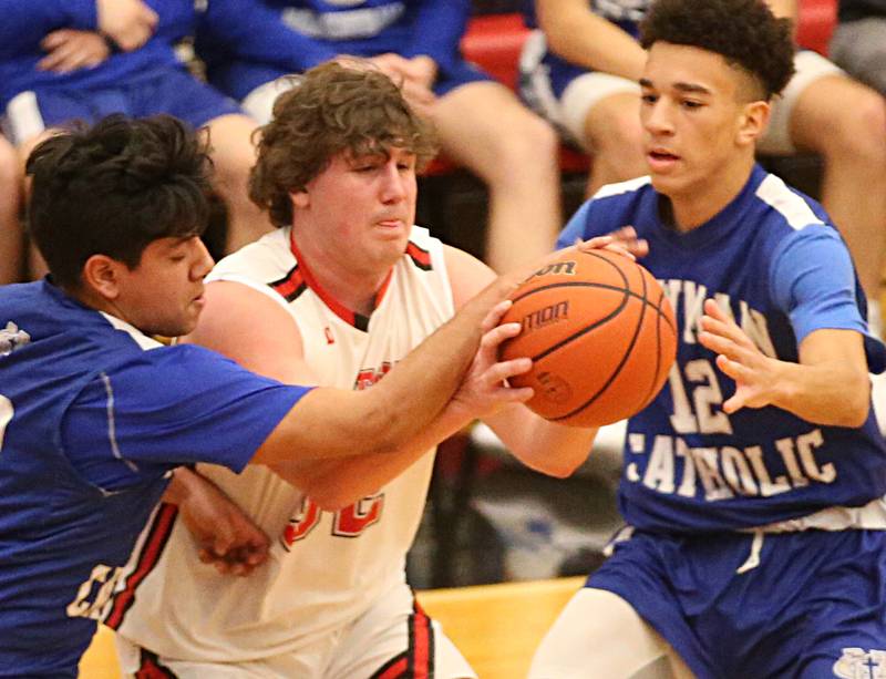 Hall's Payton Dye looks to pass the ball as Newman defenders Gabe Padilla and Isaiah Williams defend on Friday, Feb. 3, 2023 at Hall High School.