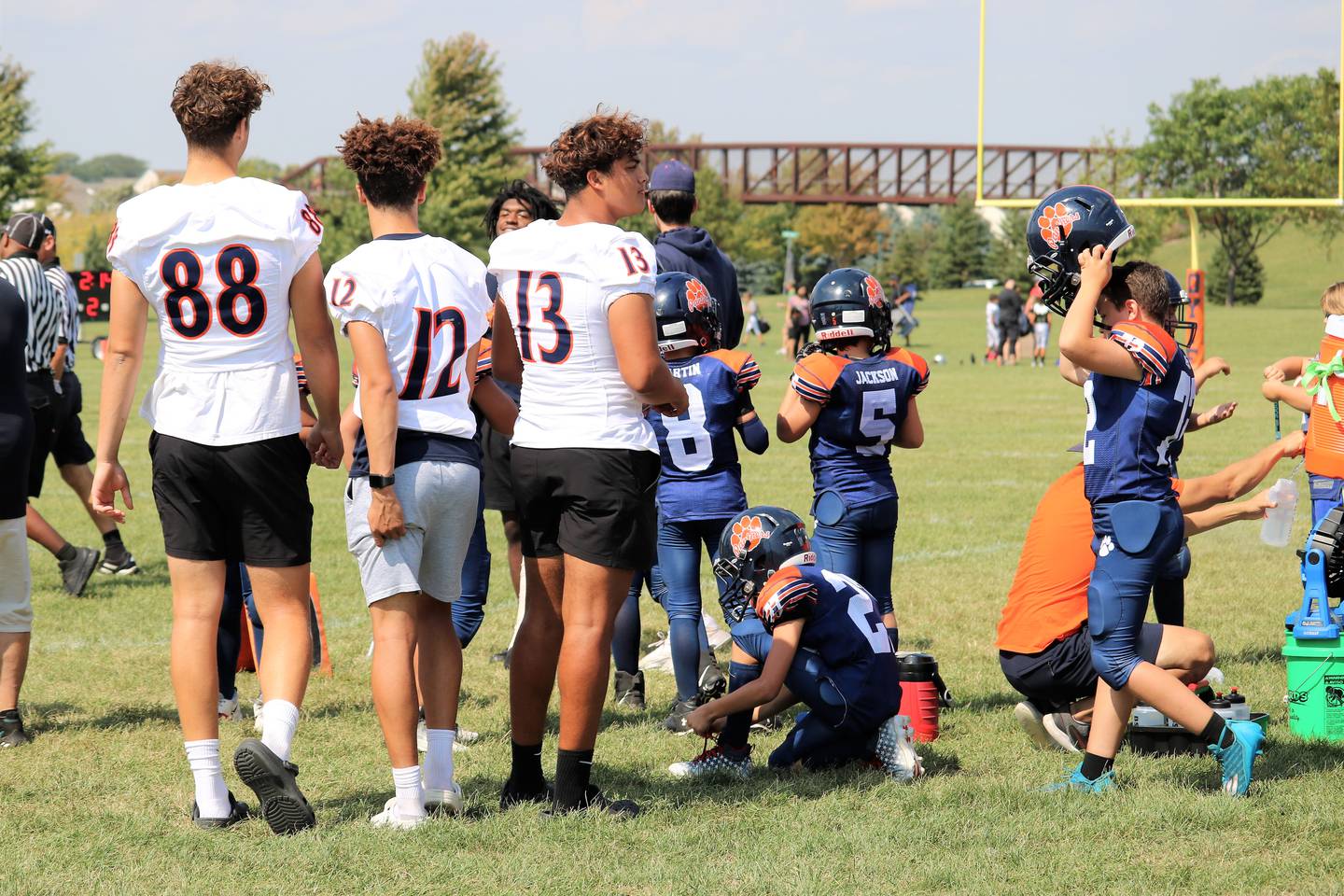 Players from the Oswego High School varsity football team attended an Oswego Youth Tackle Football game to support and encourage a 9U team on Sept. 17 2022.