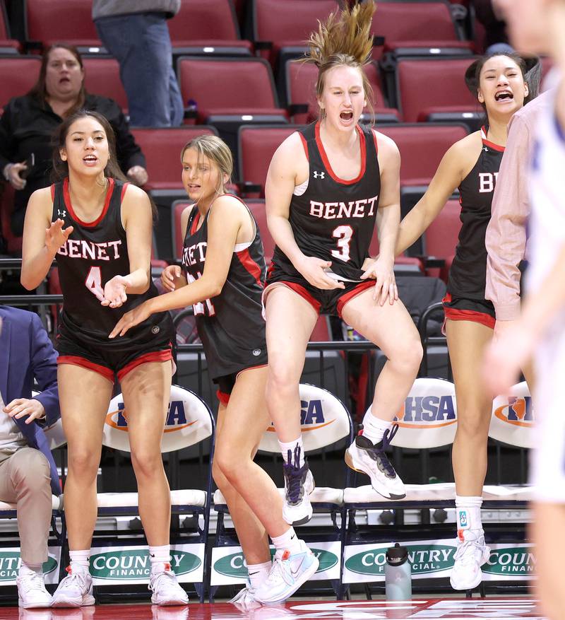 The Benet bench celebrates as a teammate goes to the line with a tie score and a chance to win the game with two seconds left during their Class 4A state semifinal game against Geneva Friday, March 3, 2023, in CEFCU Arena at Illinois State University in Normal.