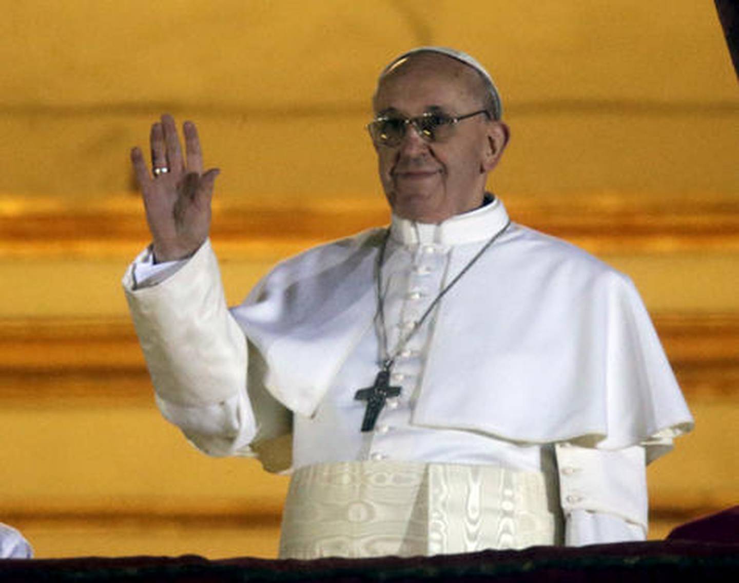 Pope Francis waves to the crowd from the central balcony of St. Peter's Basilica at the Vatican, Wednesday, March 13, 2013. Cardinal Jorge Bergoglio who chose the name of  Francis is the 266th pontiff of the Roman Catholic Church. (AP Photo/Gregorio Borgia)
