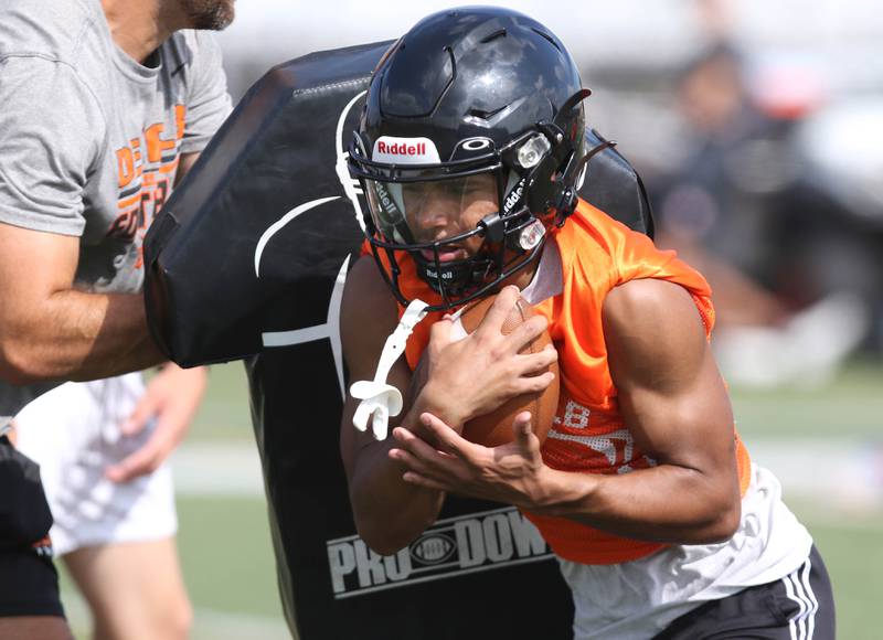 DeKalb’s Xavier Dandridge carries the ball during practice Monday, Aug. 7, 2023, at DeKalb High School.