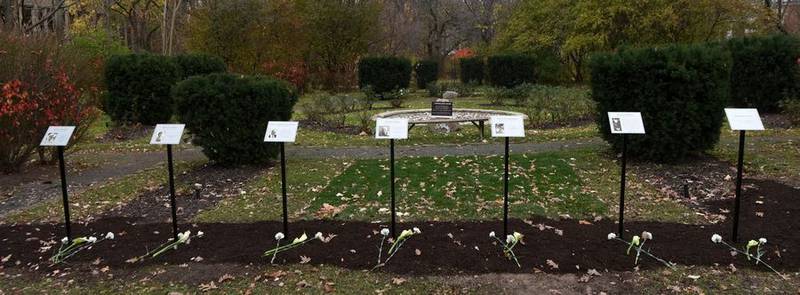 A temporary memorial, located in the Rose Garden adjacent to city hall, in remembrance of the seven victims of the July 4 shooting in Highland Park. The father of the man alleged to have carried out the attack is expected to be charged with a felony Friday. (Daily Herald photo from November 2022)