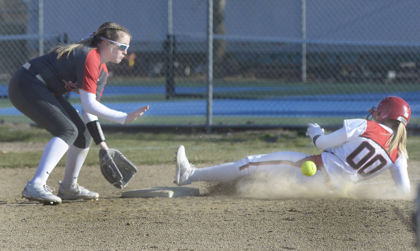 Streator's Lily Kupec (00) beats the tag at third base by Ottawa's Aubrey Sullivan on Thursday in Streator.