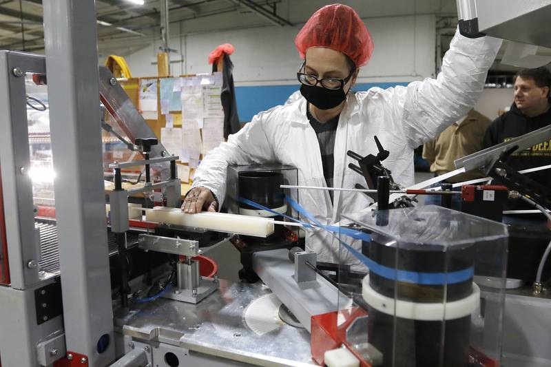 Supervisor Sherry Thrun works the machinery at BOSS Straw on Wednesday, Dec. 29, 2021 in Woodstock. The business creates 3-ply paper straws that are environmentally friendly and can last up to 24 hours in soda beverages without breaking down.