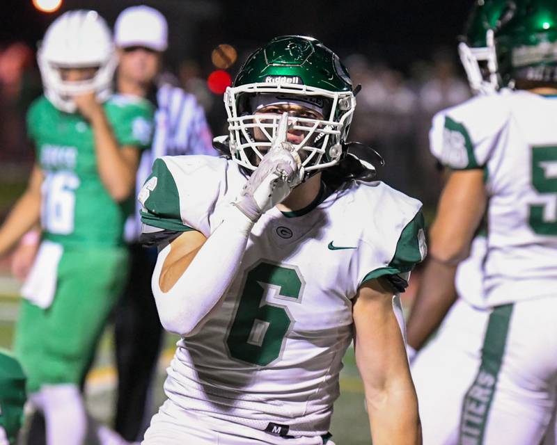 Glenbard West's Scott Segebarth (6) celebrates by hushing the York fans after tackling York's Henry Duda who carried the ball during the game on Friday Oct. 17, 2025, held at York High School.