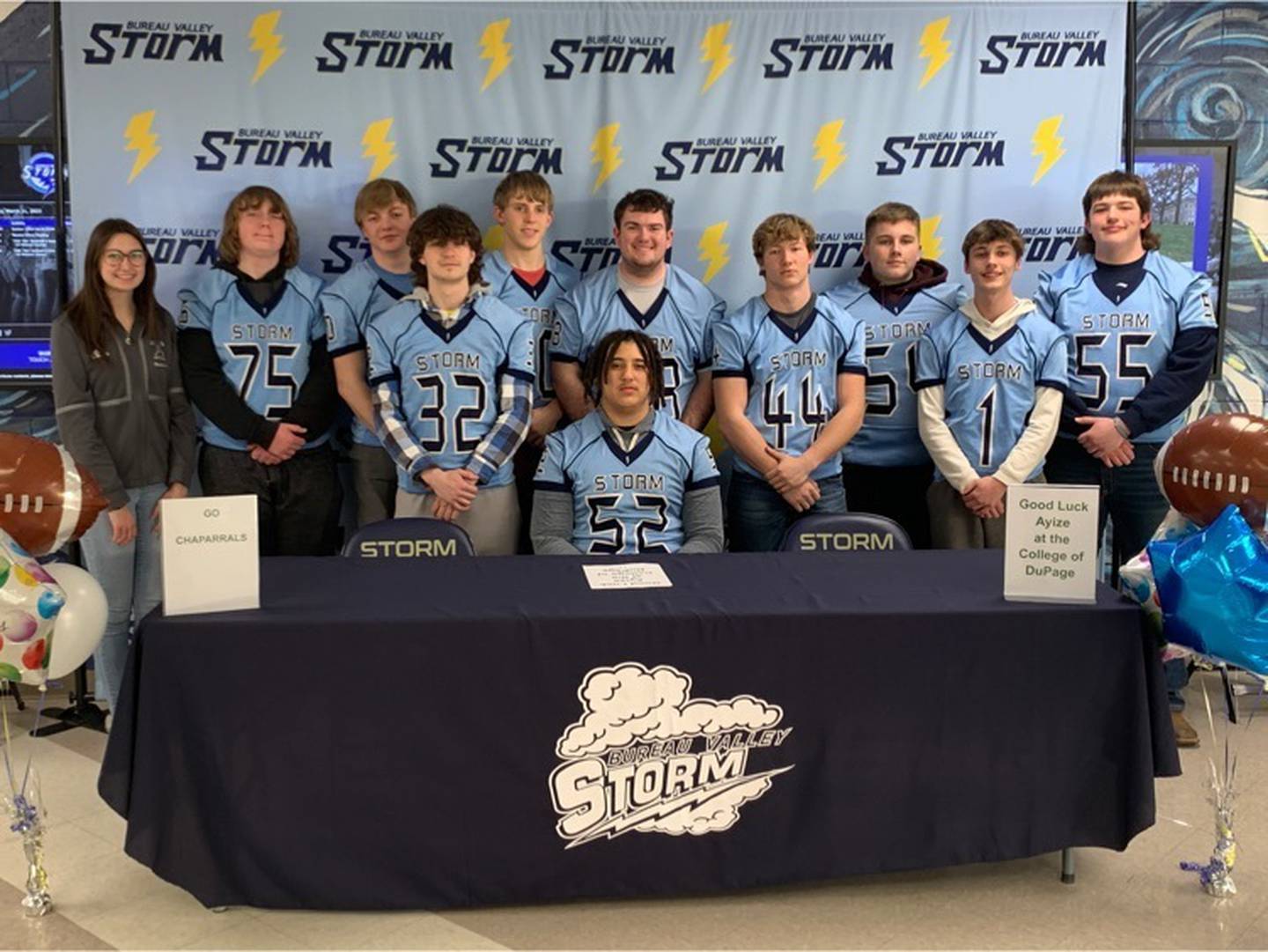 Bureau Valley senior Ayize Martin is joined by his Storm teammates on his signing day with the College of DuPage.