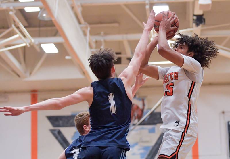 Wheaton Warrenville South's Braylen Meredith (25) shoots over Lake Park's Camden Cerese (1) during a game on Saturday, Jan. 7, 2023.