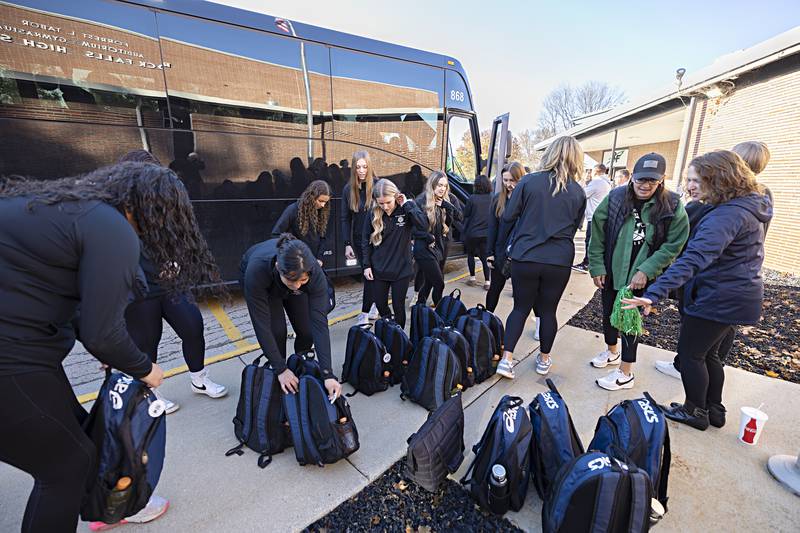 Rock Falls volleyball team members pick up their luggage before getting on the bus for Normal Thursday, Nov. 9, 2023.