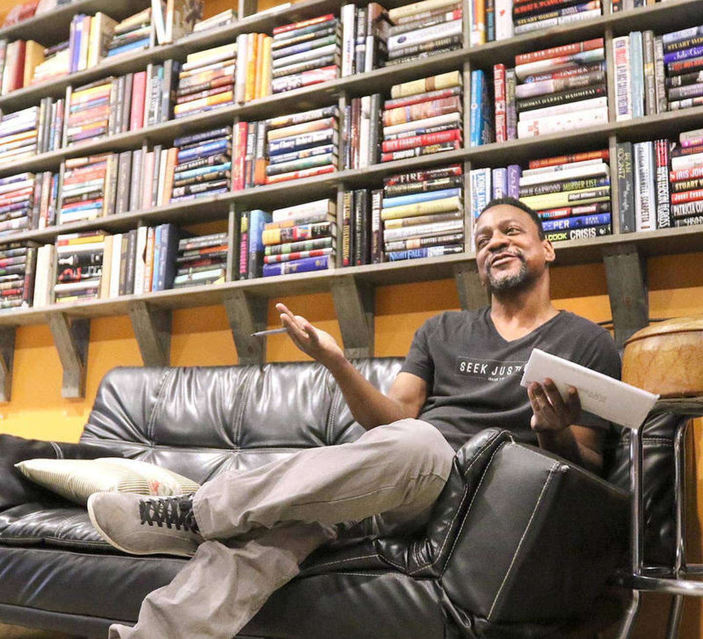 Jeff Foster, owner of Common Grounds coffee shop in DeKalb, talks Wednesday, June 10, 2020, at the cafe about being a black man and a business owner and how he hopes to encourage young black artists in the community.