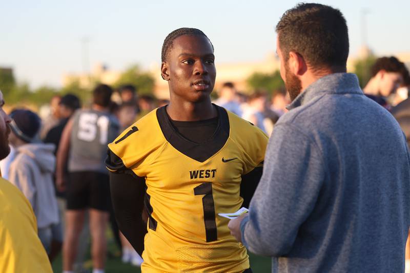 Joliet West’s Sinaayomi talks with a college scout at the IHSA Southwest Suburb Showcase combine on Thursday, May 7, 2026 at Plainfield North High School.