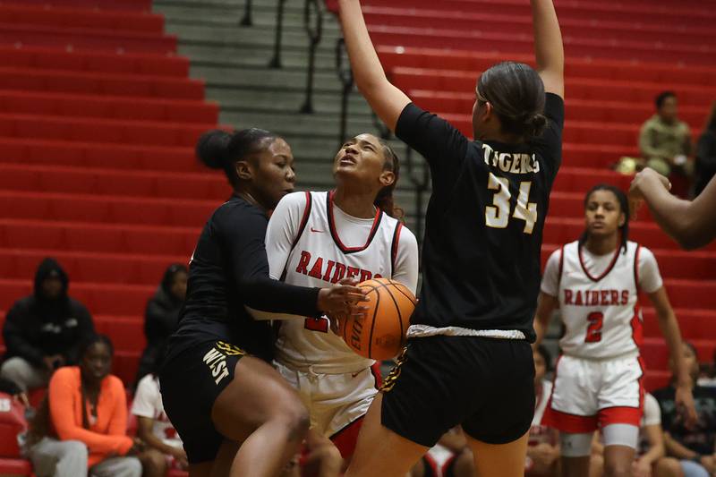 Bolingbrook’s Makayla Edwards draws the foul under the basket against Joliet West on Thursday, Jan 23, 2025 in Bolingbrook.