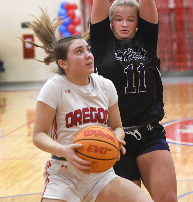 Oregon's Lola Schwarz makes a move to the basket as Rockford Lutheran's Laney Carlson defense during a Saturday, Jan. 24, 2026 game at the Blackhawk Center in Oregon.