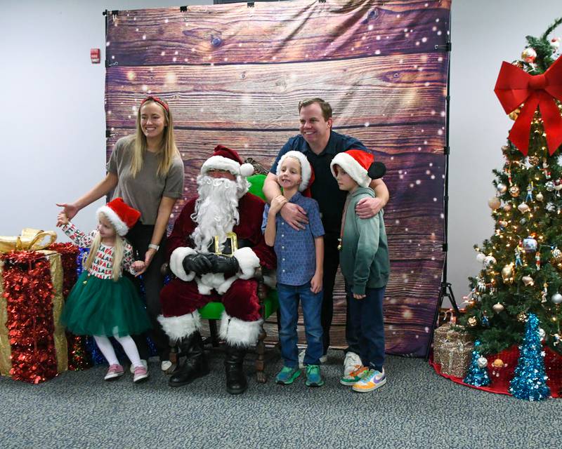 Holly king along with her husband Simon King and kids Carmeron King, 7, Noah King, 7, and Chloe King, 4, all pose for a photo wit Santa during the breakfast with Santa event on Sunday Dec. 15, 2024, held at the La Grange Park District Recreation Center.