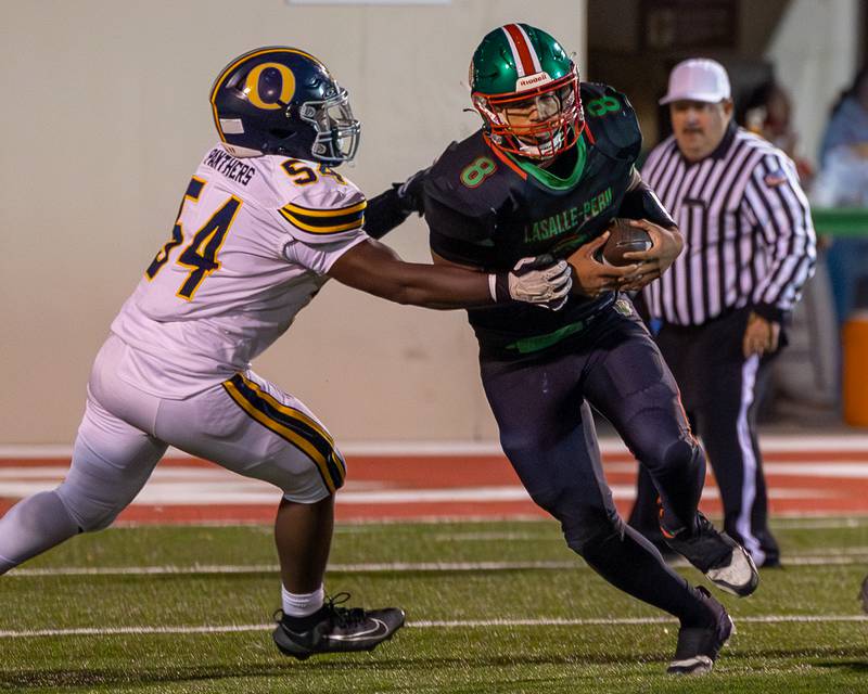 Marion Persich (8) of L-P runs ball as Aaron Fowler (54) of O' Fallon attempts to tackle on Friday, October 24, 2025 at Howard Fellows Stadium in LaSalle.