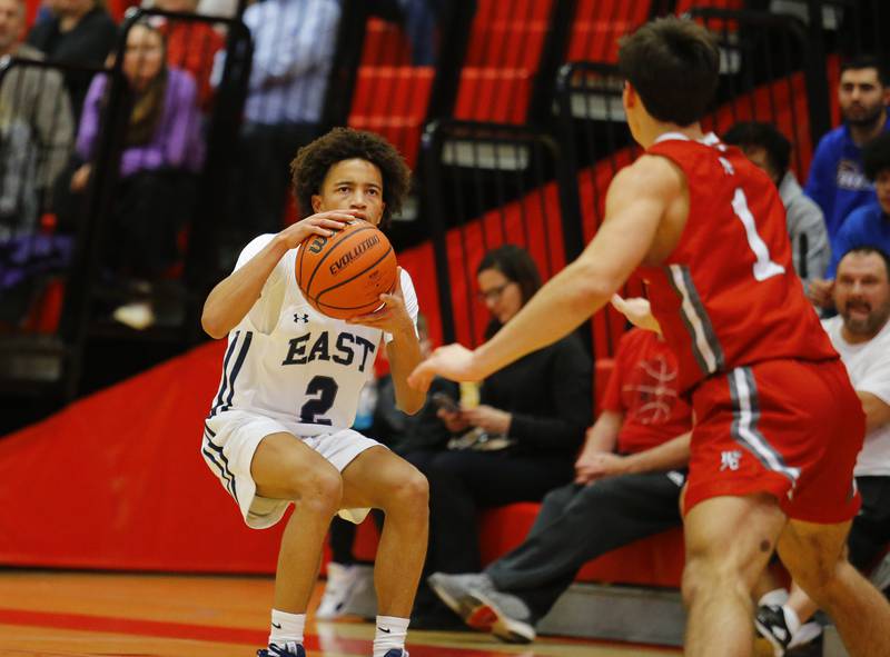 Oswego East's Bryce Wiggins (2) pulls up to take a shot during the Hinsdale Central Holiday Classic championship game between Oswego East and Hinsdale Central high schools on Thursday, Dec. 29, 2022 in Hinsdale, IL.