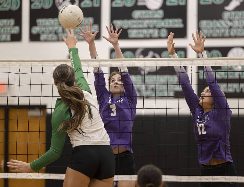 Rochelle’s Kyrie Cragin (left) and Jillian Bruns go up for a block against Rock Falls' Addison Miller Monday, Sept. 29, 2025.