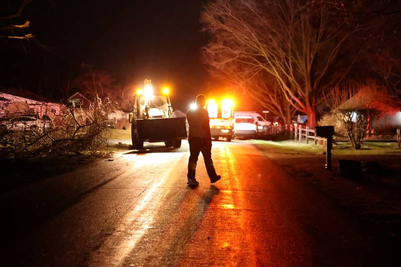 Emergency crews work to clear Strasma South Drive in Aroma Park after severe thunderstorms and a tornado passed through the area on March 10, 2026.