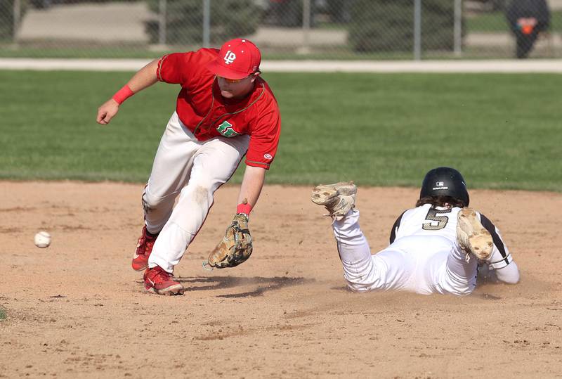 Sycamore's Tyler Lojko slides in with a stolen base as La Salle-Peru's Kaedin Bond fields the late throw Wednesday, April 23, 2025, during their game at the Sycamore Community Sports Complex.