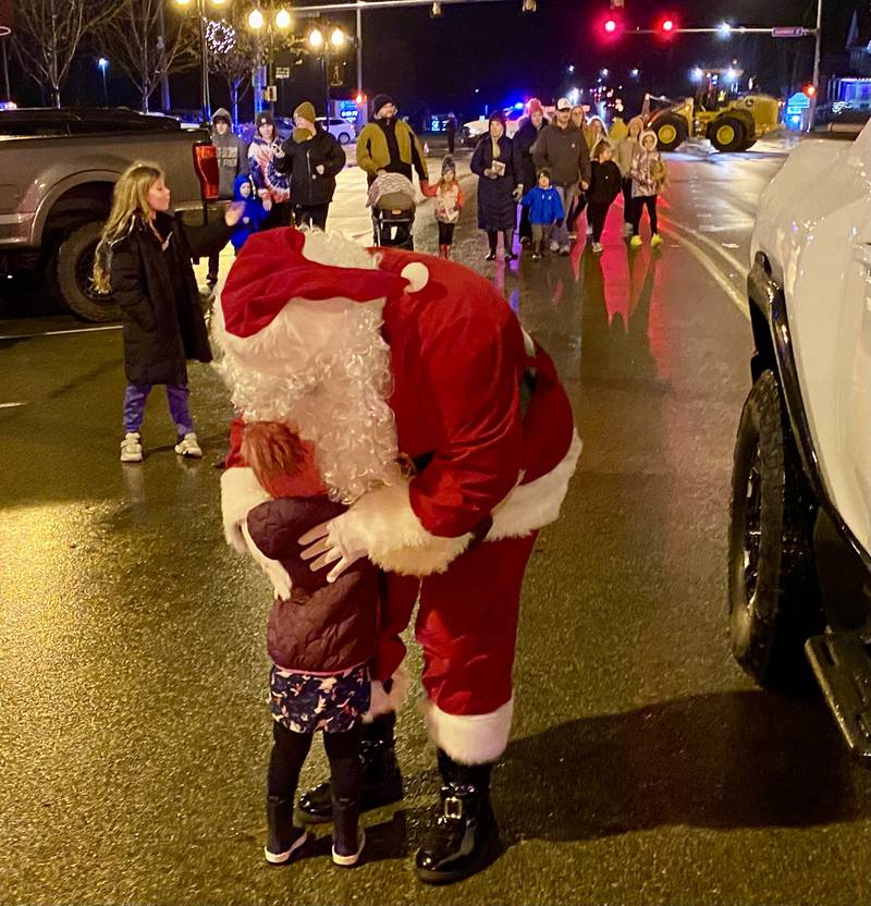 Santa Claus greets children along State Street in downtown Sycamore for Discover Sycamore's annual Walk with Santa on Friday, Dec. 1, 2023.