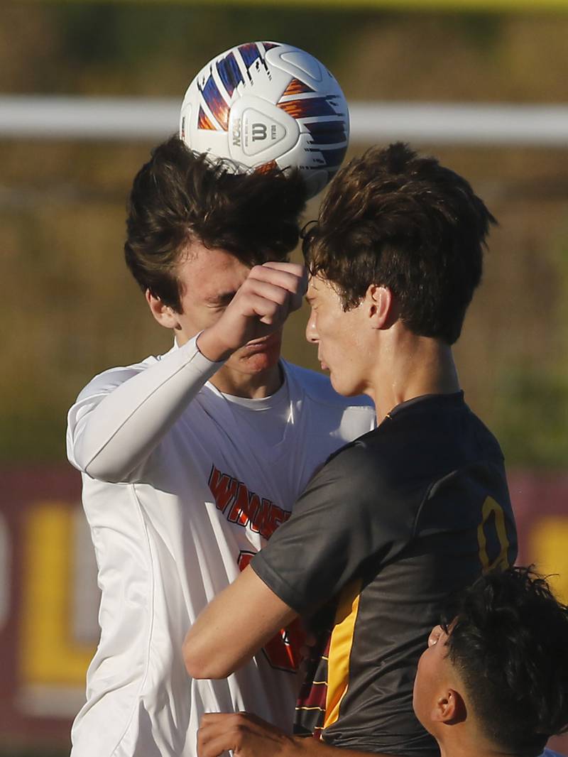 Winnebago's Eli Intravaia tries to head the ball way Richmond-Burton's Dalton Youngs from during the IHSA Class 1A Richmond-Burton Regional Final soccer match Tuesday, Oct. 17, 2023, at Richmond-Burton High School in Richmond.