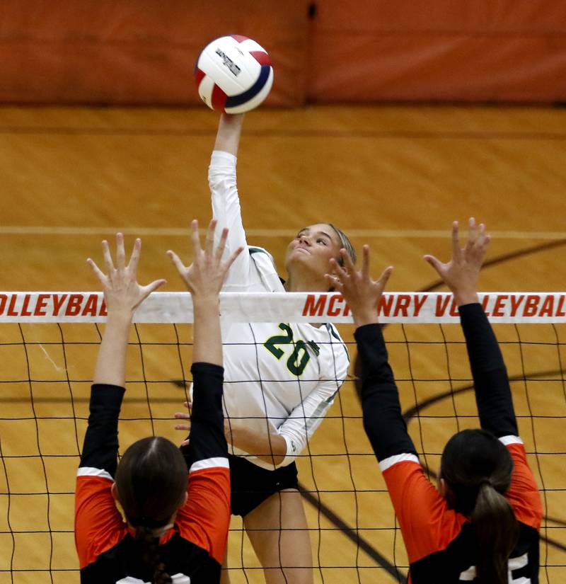 Crystal Lake South's Bobbi Wire hits the ball over the block attempt of McHenry's Teage Wings and Jasmin Villegas (right) during a Fox Valley Conference volleyball match on Thursday, Aug. 28, 2025, at the Freshman Campus of McHenry High School in McHenry.