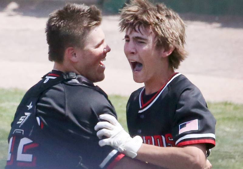Henry-Senachwine catcher Colton Williams reacts with Carson Rowe after scoring the winning run to defeated Newman in the Class 1A State semifinal game on Friday, June 2, 2023 at Dozer Park in Peoria.