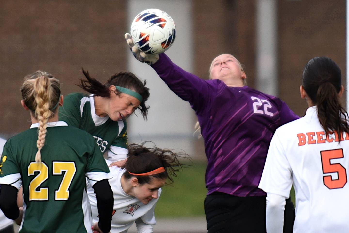 Beecher goalkeeper Mikenna Burdick (22) gets her hand on a corner kick before Coal City's Hayden Francisco can get her head on it during the Class 1A Manteno Regional championship Tuesday, May 20, 2025.