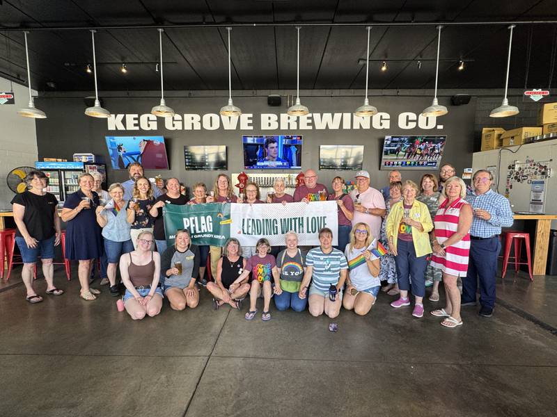 Caption: PFLAG Morris / Grundy Area celebrated one year of supporting LGBTQ+ families. In place of a chamber ribbon cutting, PFLAG members, chamber representatives, and city officials had a toast at Keg Grove Brewing in conjunction with the launch of their "Love is Love" Brew.