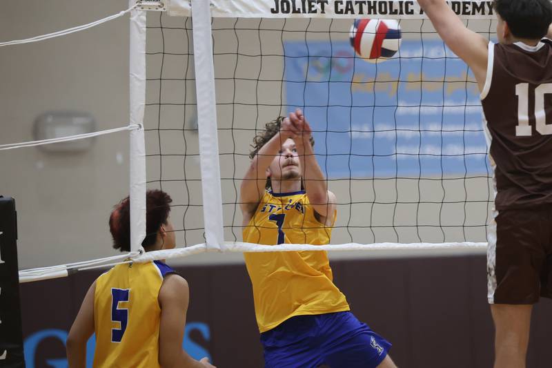 Joliet Central’s Logan Novak keeps the volley alive against Joliet Catholic on Wednesday, April 1, 2026 in Joliet.