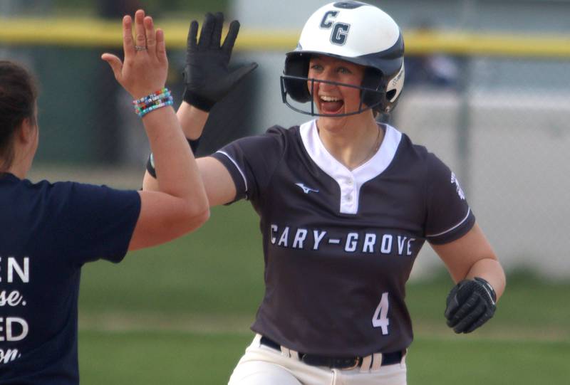 Cary-Grove’s Maddie Crick celebrates at third base with a triple against Burlington Central in varsity softball at Cary Monday. With the triple, Crick hit for the cycle.