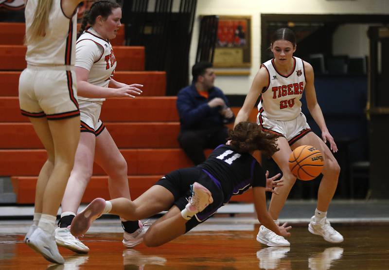 Hampshire's Mikala Amegasse passes the ball as she falls to the floor while trying to drive against. Crystal Lake Central's Hadley Ferrero during a a Fox Valley Conference basketball game on Friday, Feb. 7, 2025, at Crystal Lake Central High School.